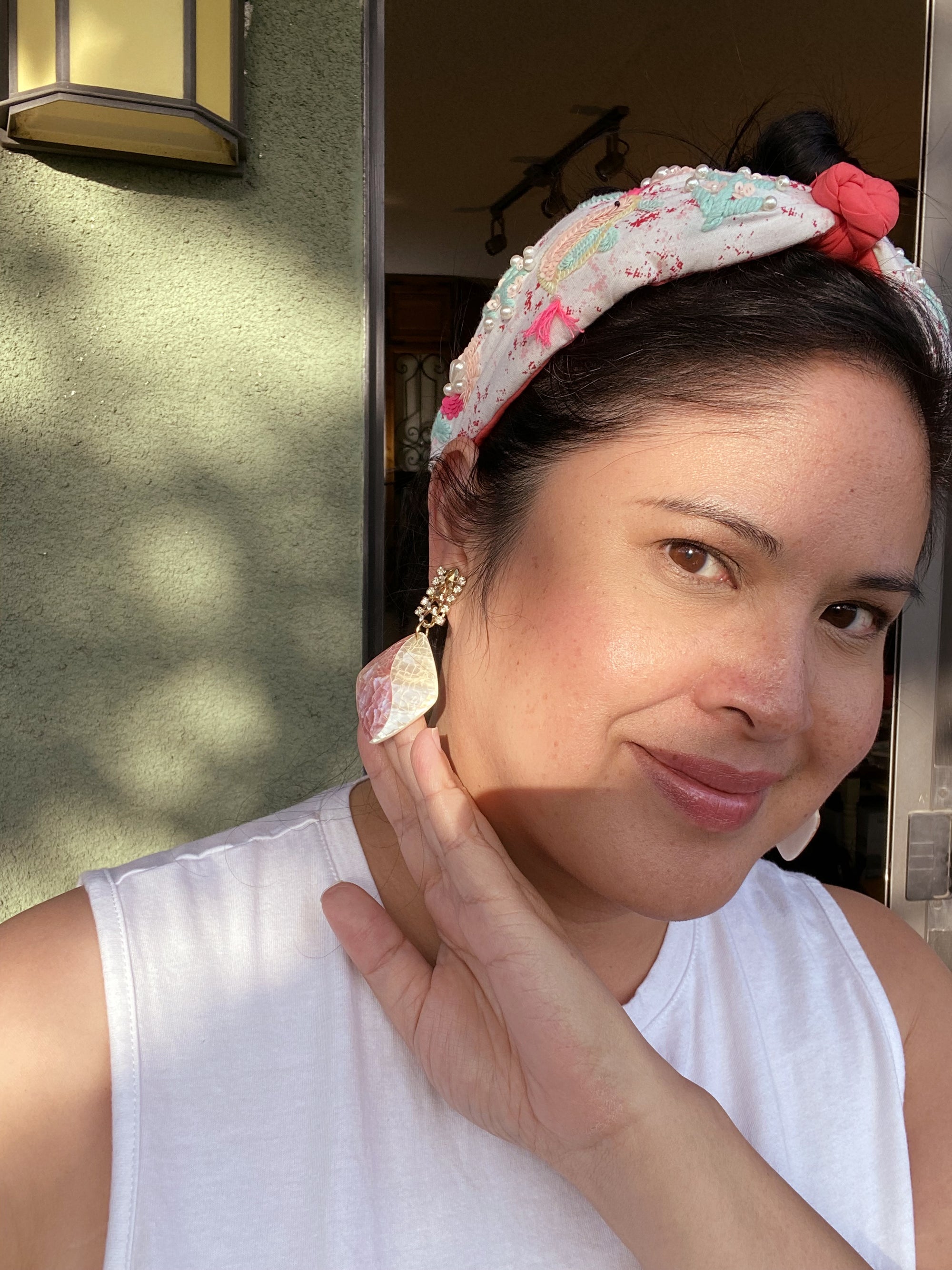 Jenny Dayco wearing Hathor pink and white shell earrings