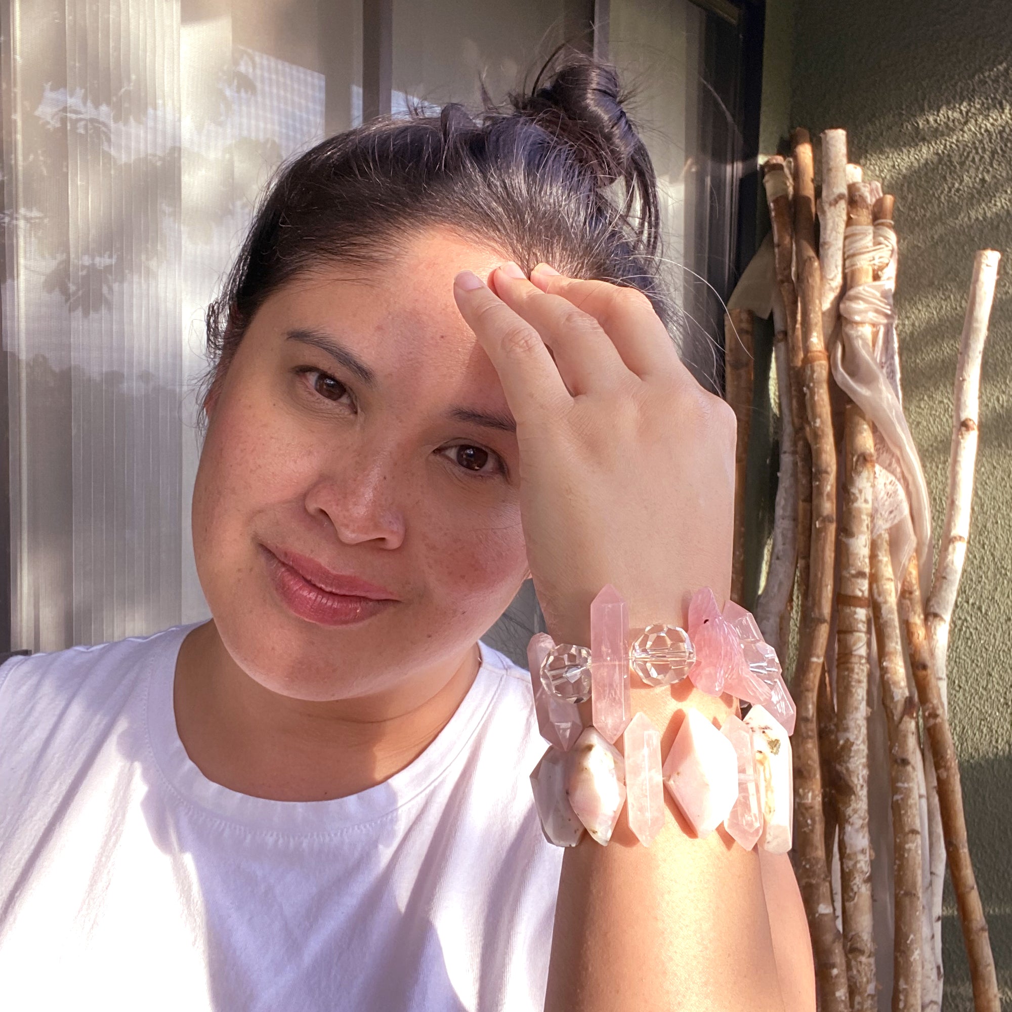 Jenny Dayco wearing a pink opal akala bracelet and rose quartz wolf bracelet