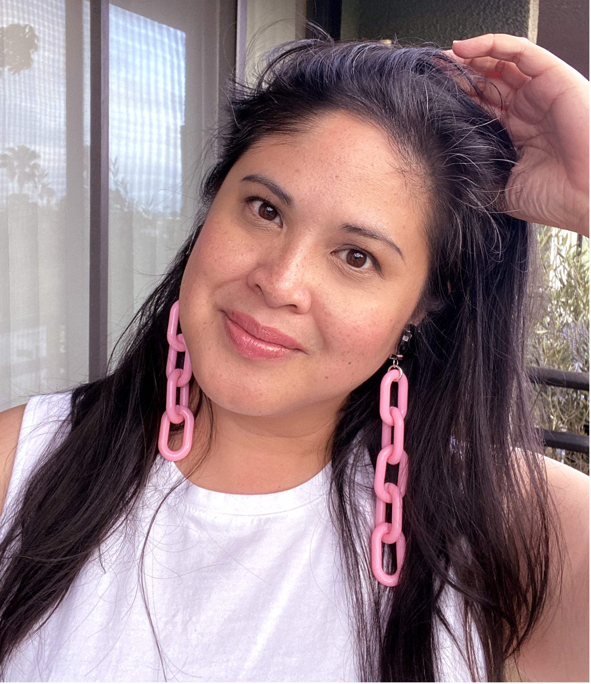 Jenny Dayco wearing black glass and pink chain earrings