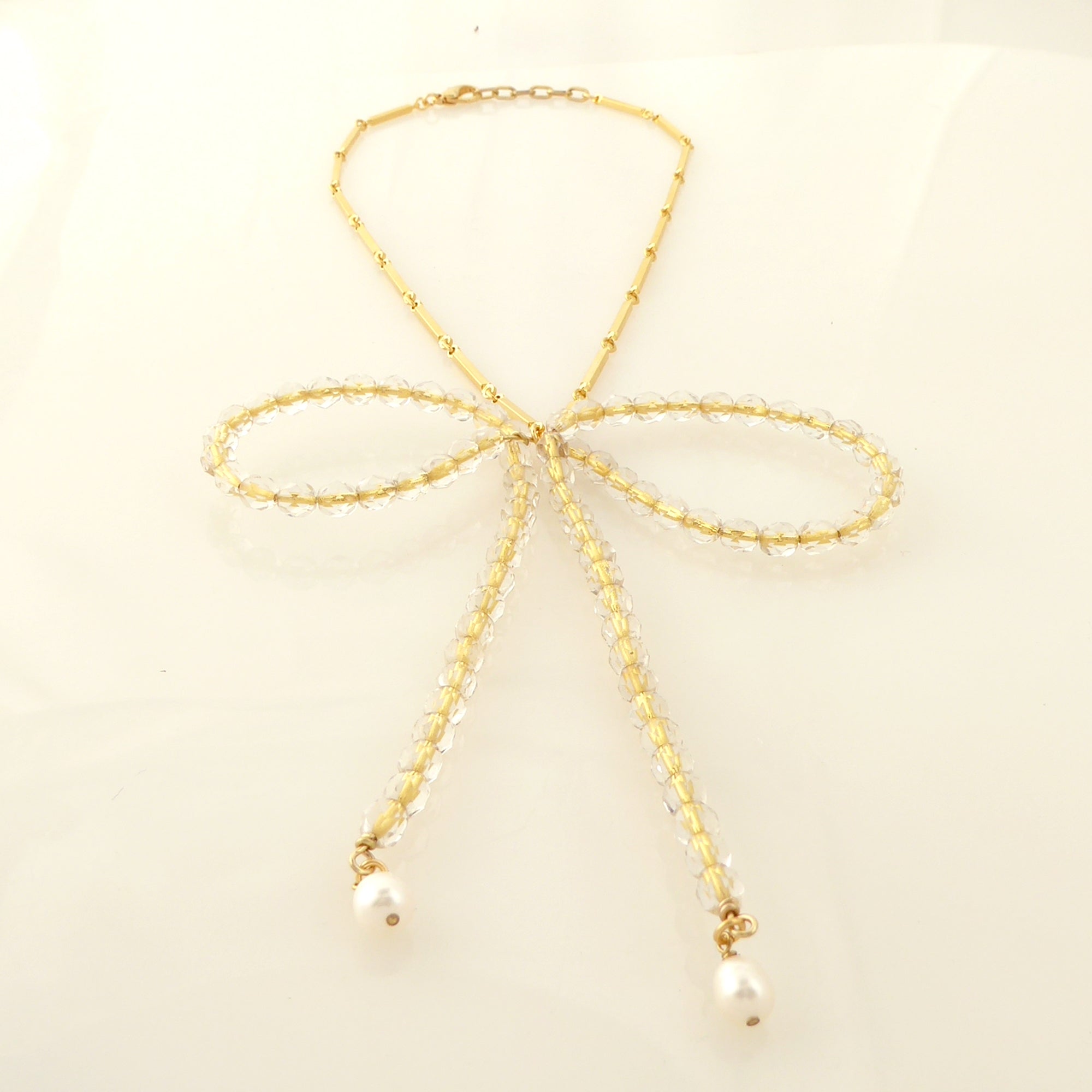 Golden beaded bow necklace by Jenny Dayco 3