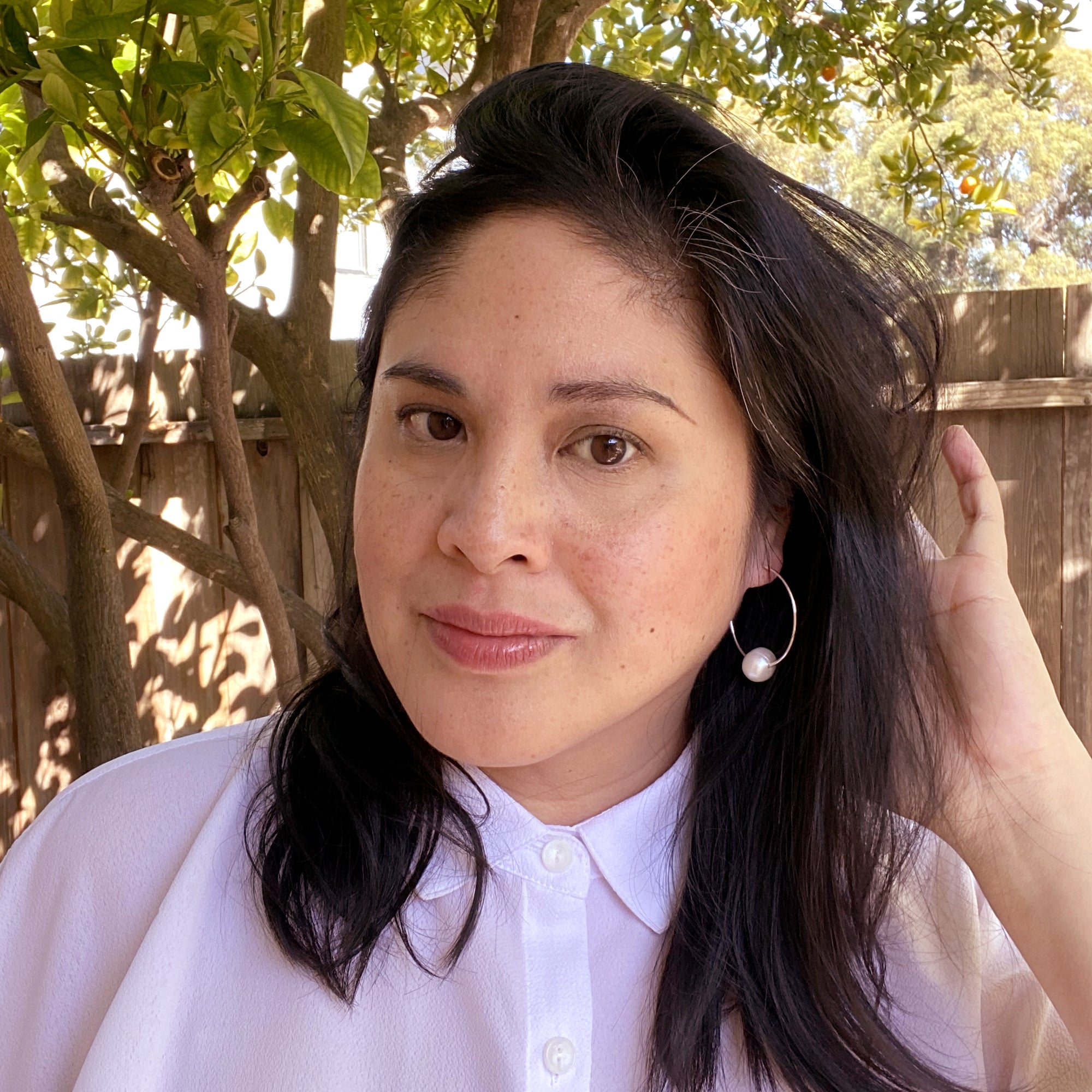 Jenny Dayco wearing large sterling silver hoop and pearl earrings