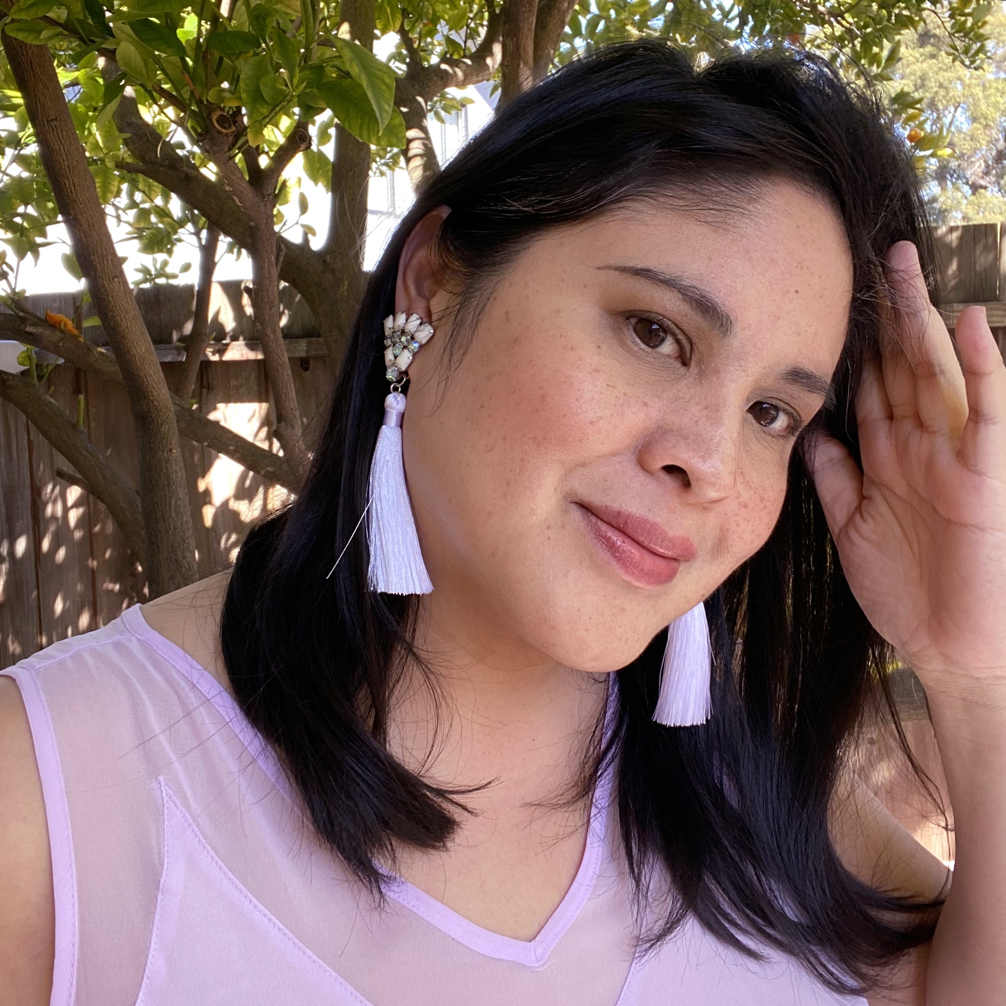 Jenny Dayco wearing rhinestone fan and silk tassel earrings