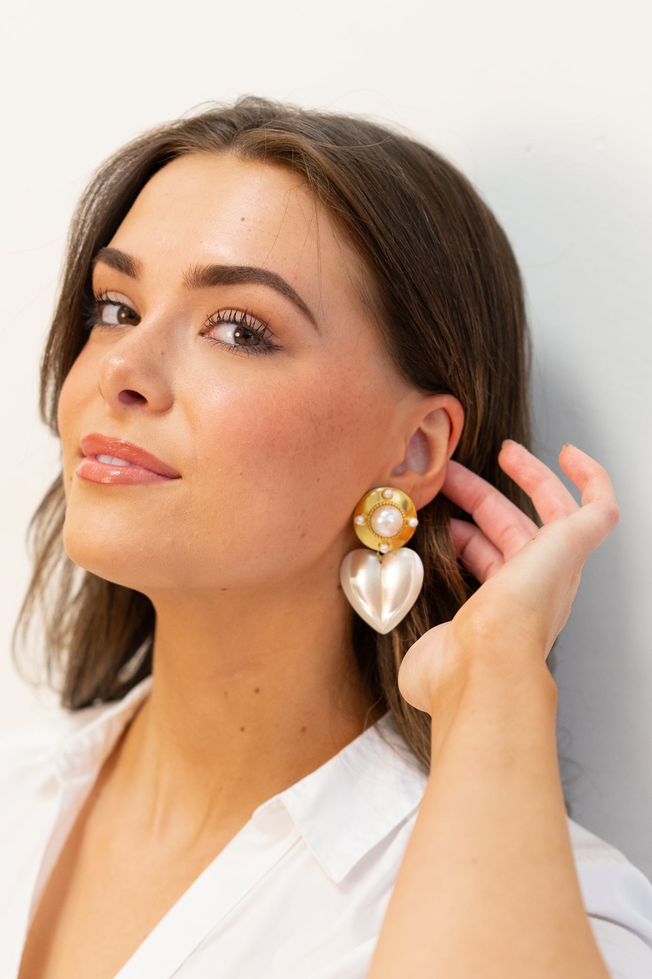 Pearl shield earrings on model by Jenny Dayco 1