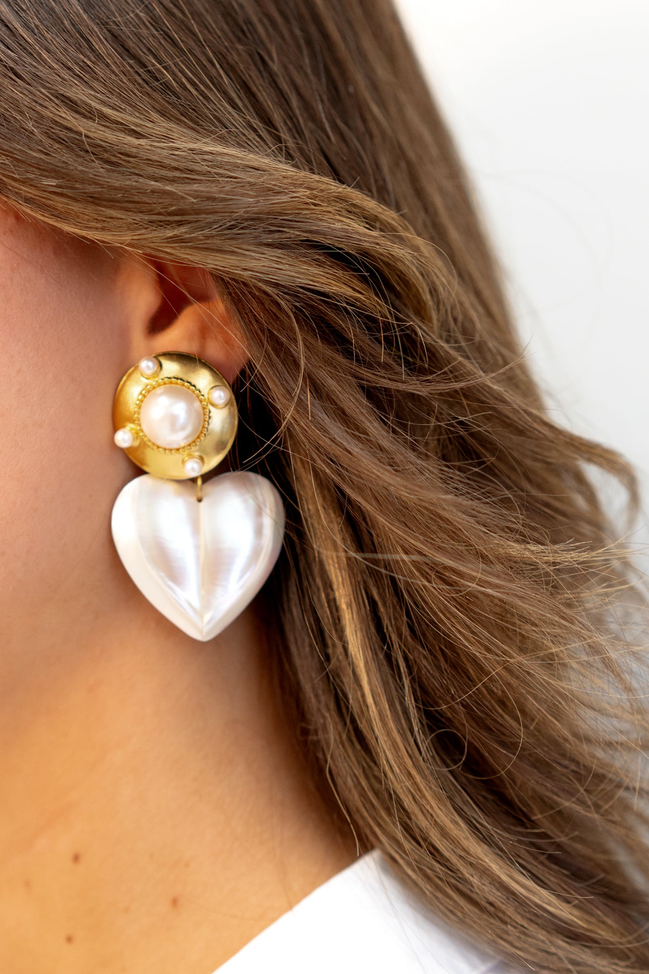 Pearl shield earrings on model by Jenny Dayco 2