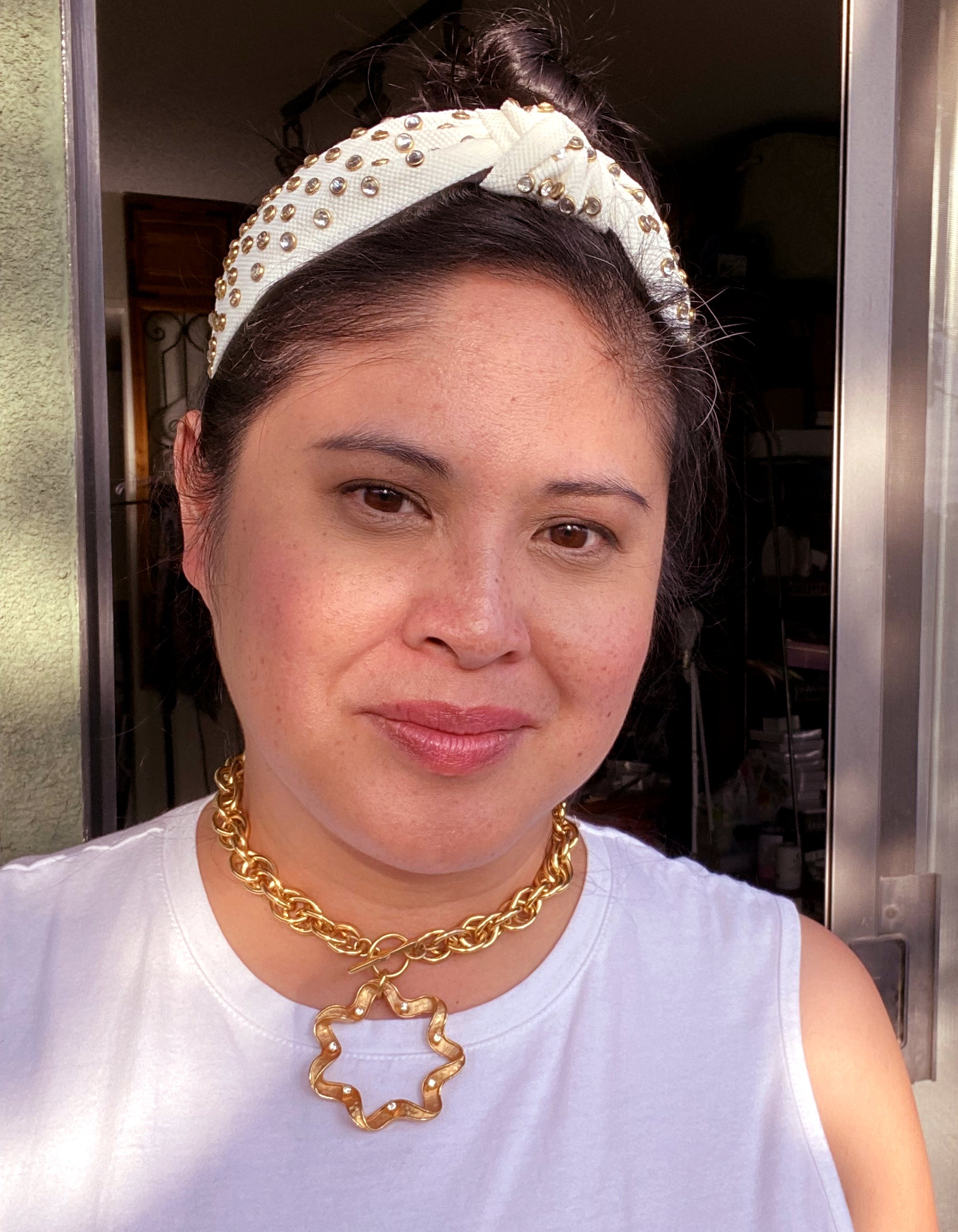Jenny Dayco wearing a gold estelita rhinestone toggle necklace
