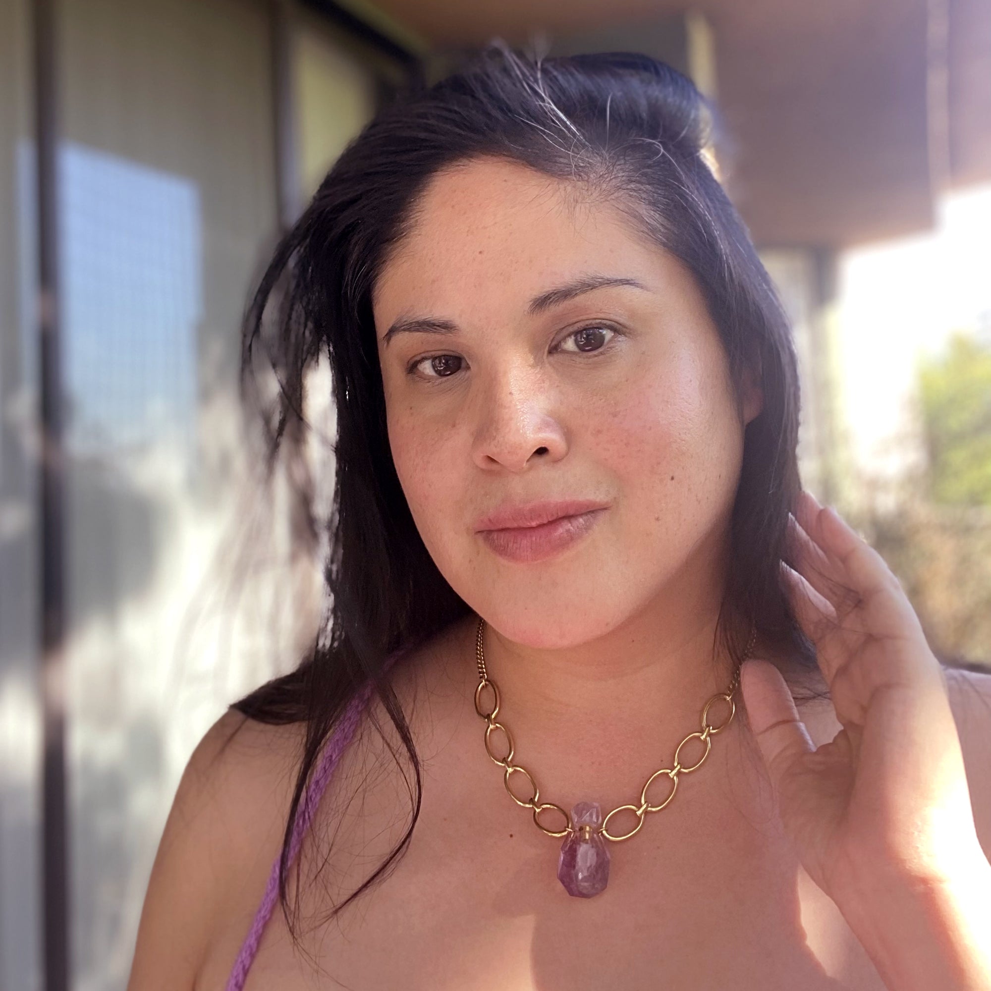 Jenny Dayco wearing an amethyst vial necklace