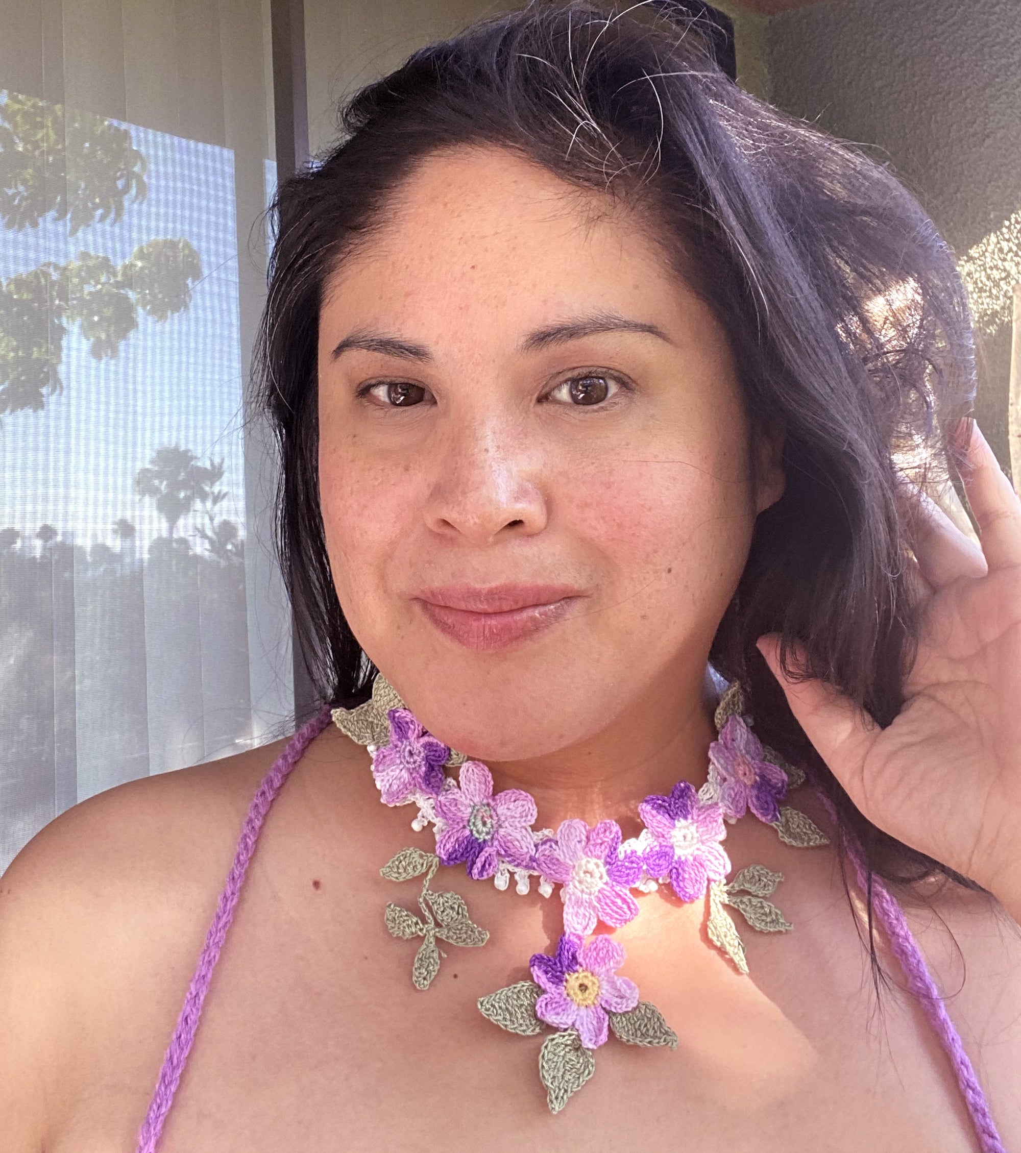 Jenny Dayco wearing a purple daisy crochet necklace