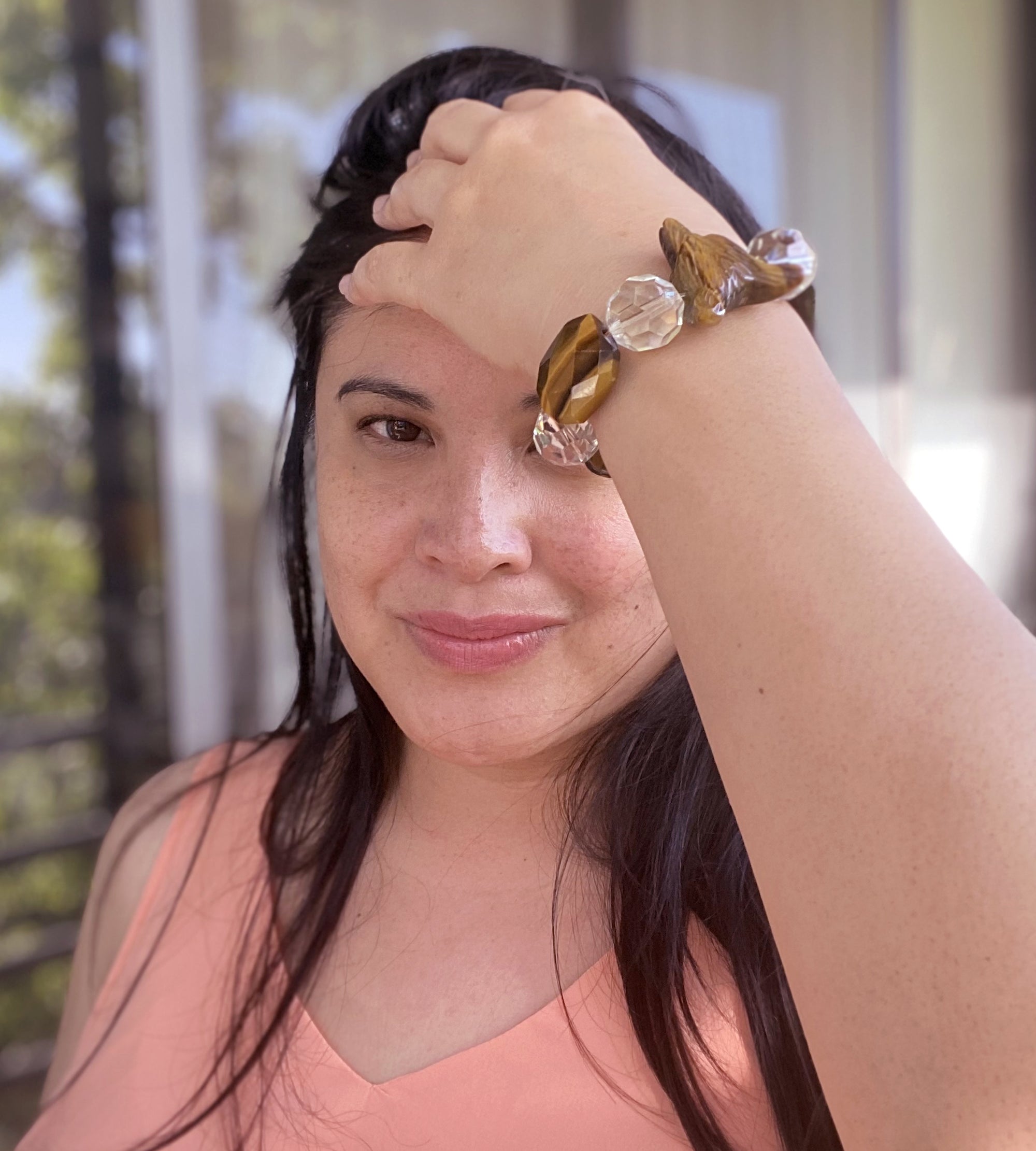 Jenny Dayco wearing a tigers eye wolf and quartz bracelet