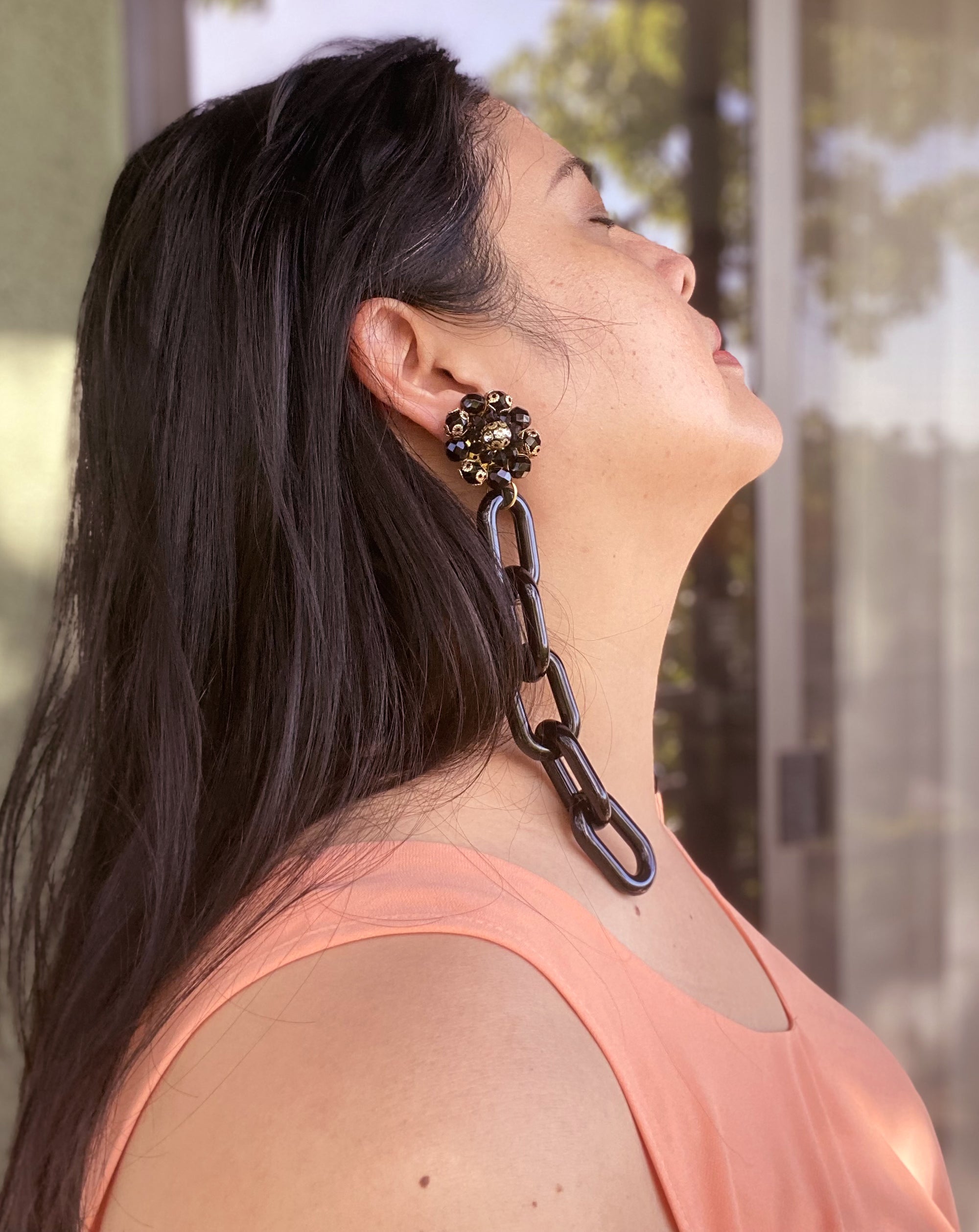 Jenny Dayco wearing black glass cluster earrings