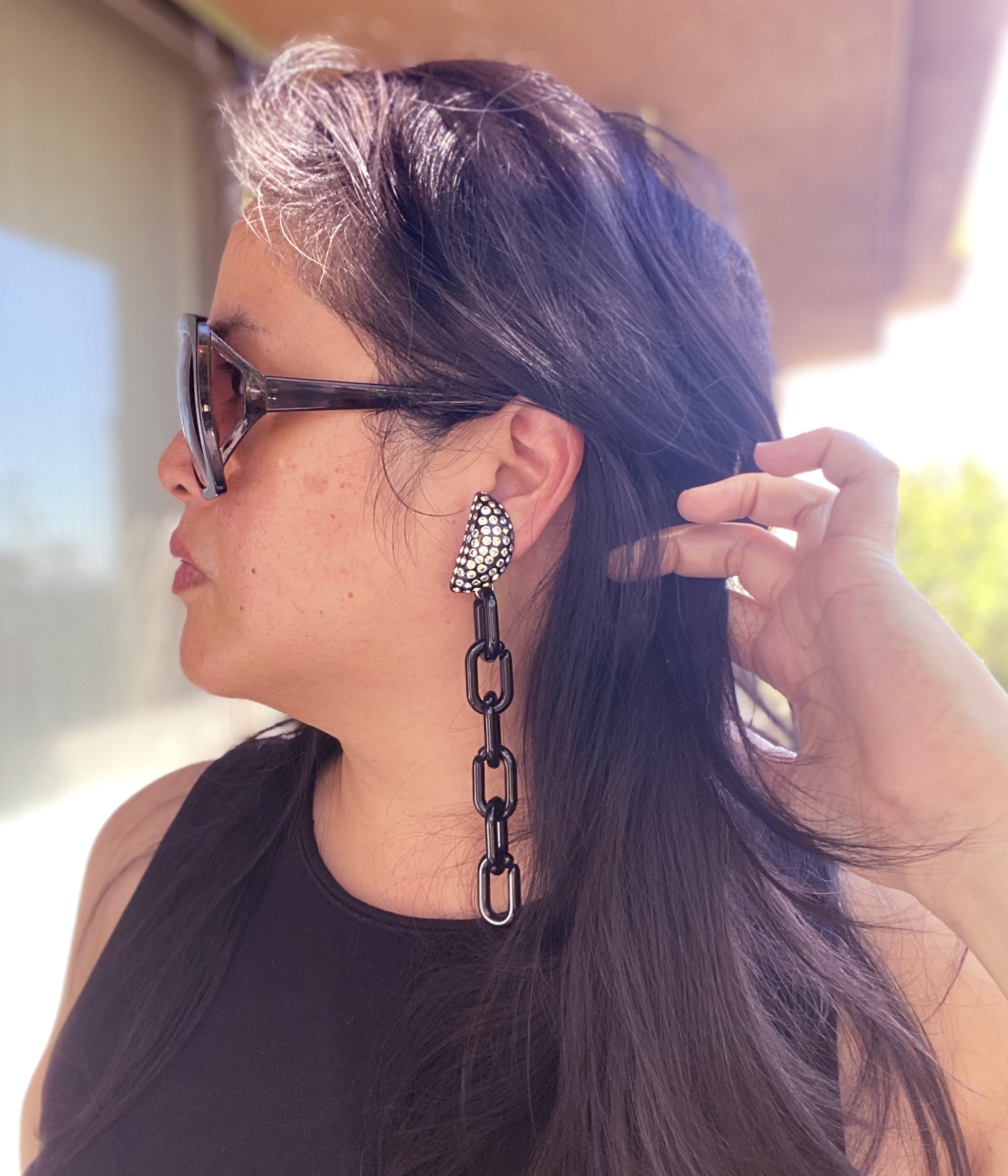 Jenny Dayco wearing black rhinestone moon earrings