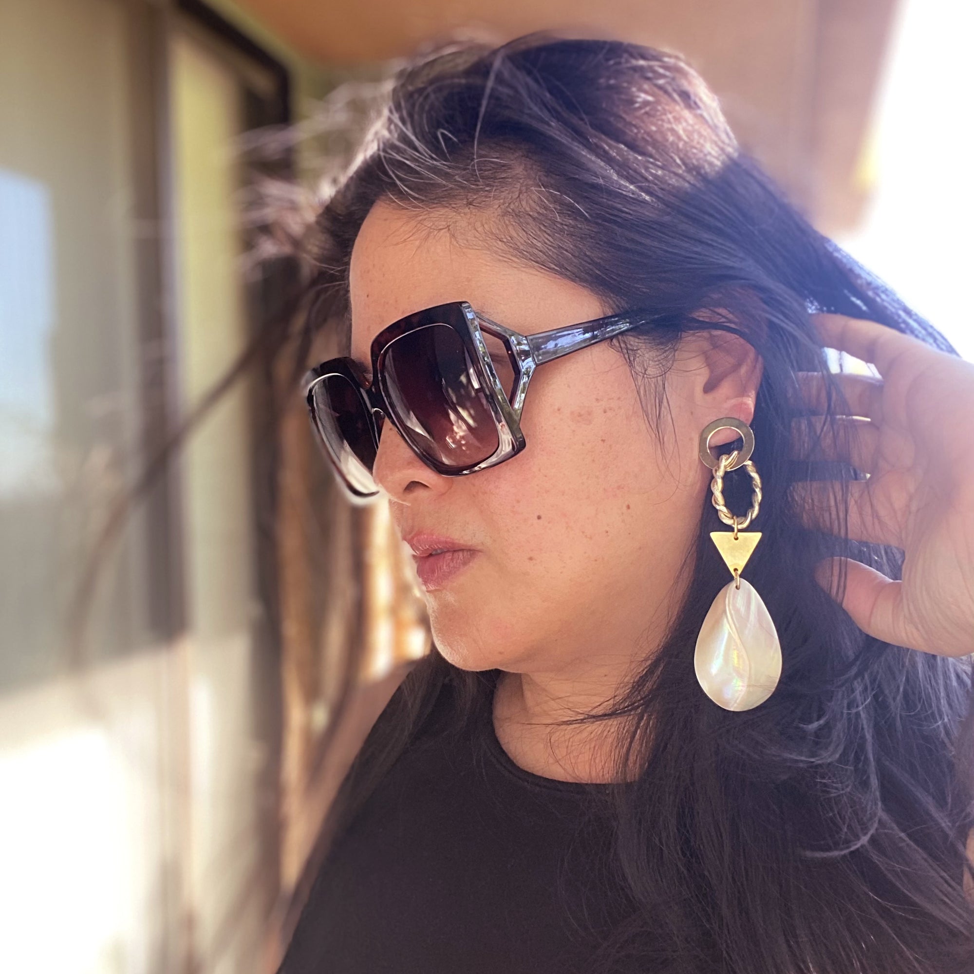Jenny Dayco wearing geometric mother of pearl earrings