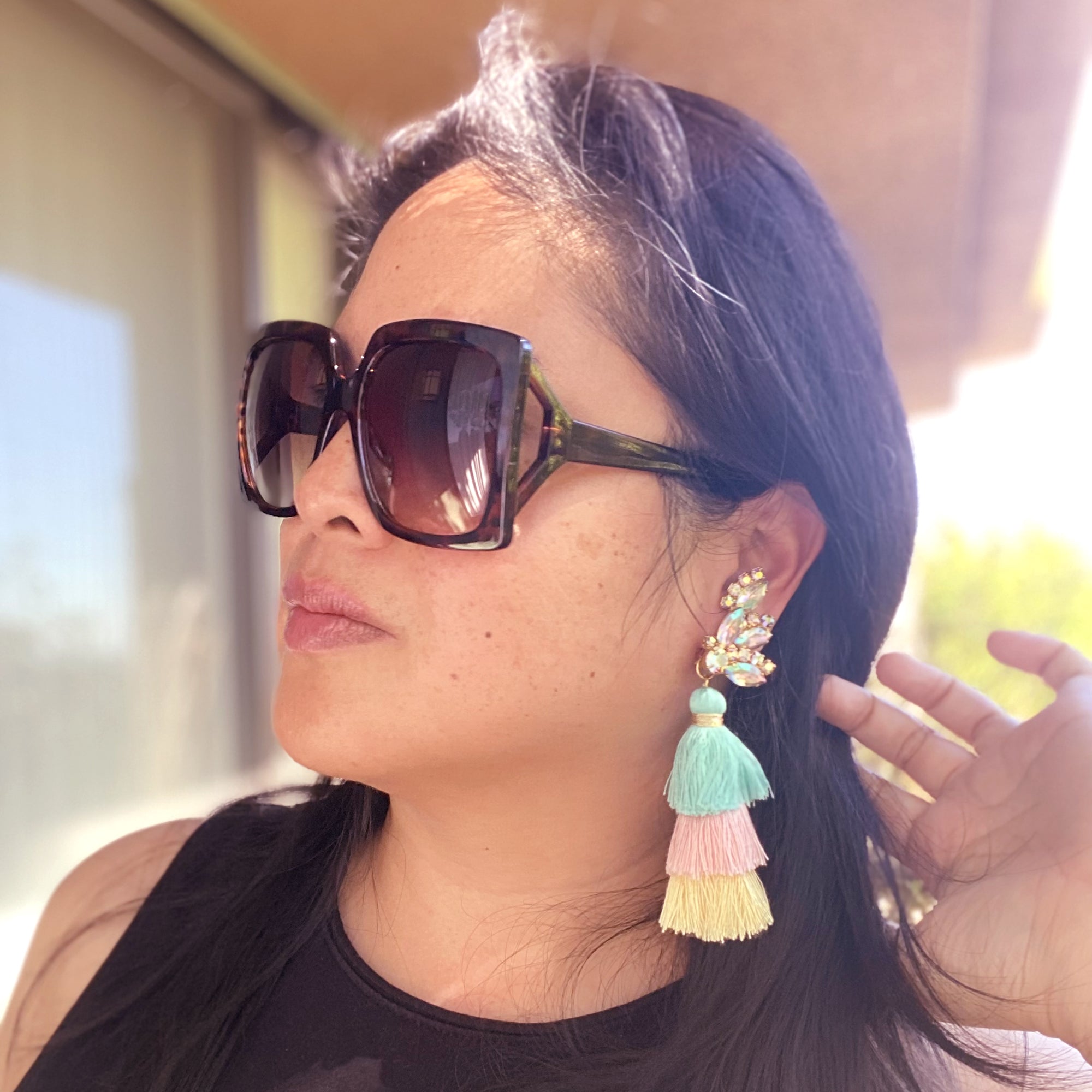Jenny Dayco wearing iridescent rhinestone tassel earrings