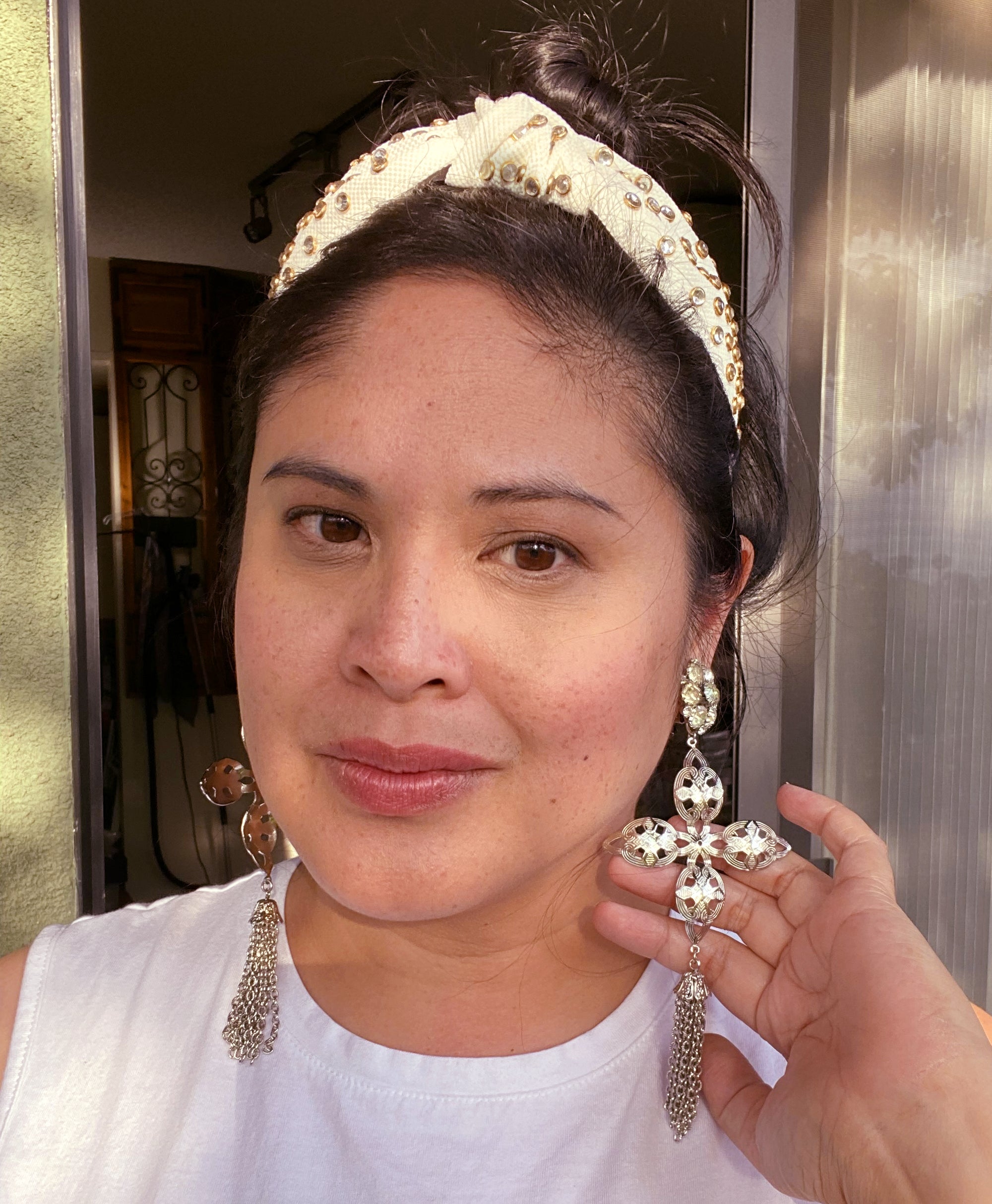 Jenny Dayco wearing silver star crossed rhinestone and tassel earrings