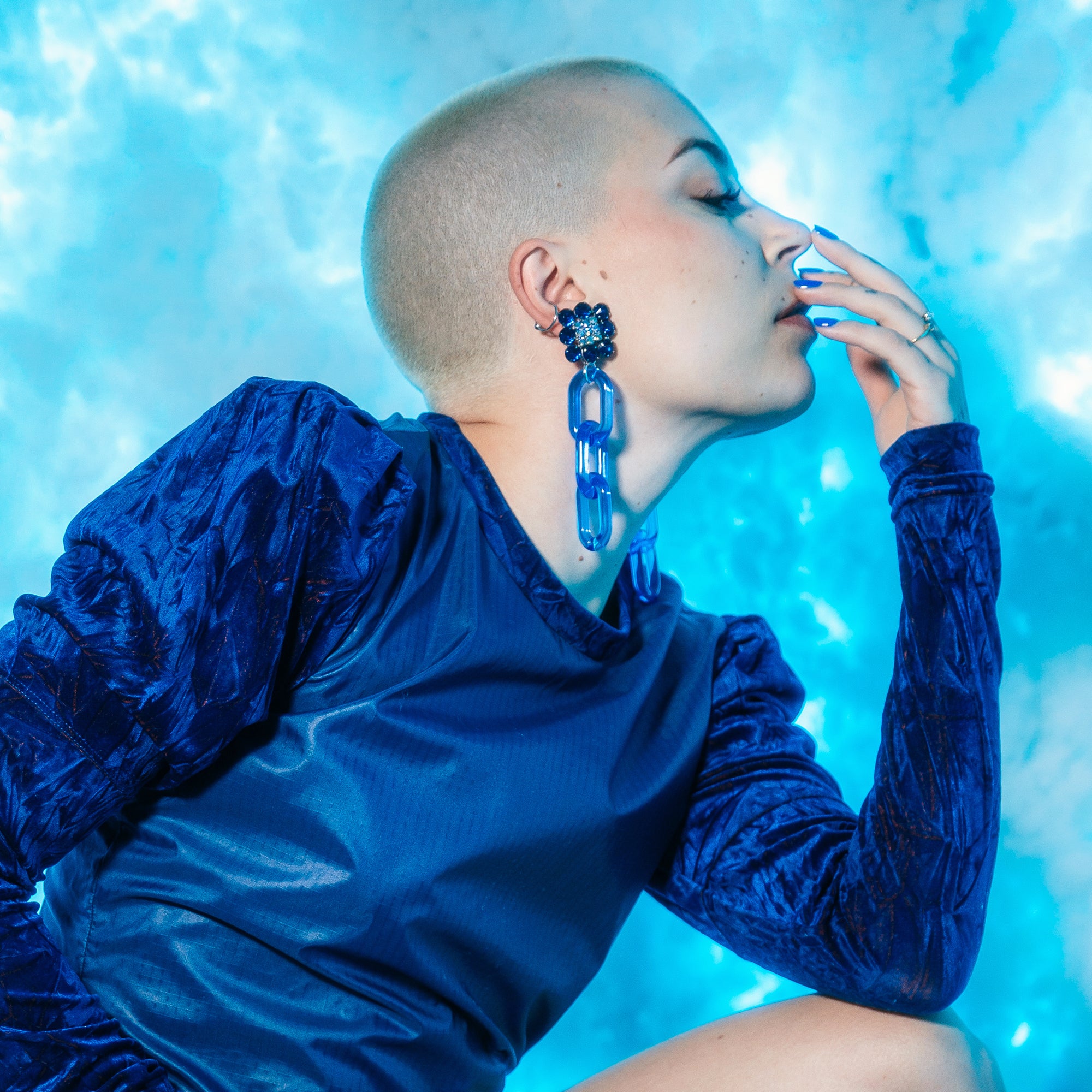 Model wearing Jenny Dayco blue rhinestone chain earrings 1