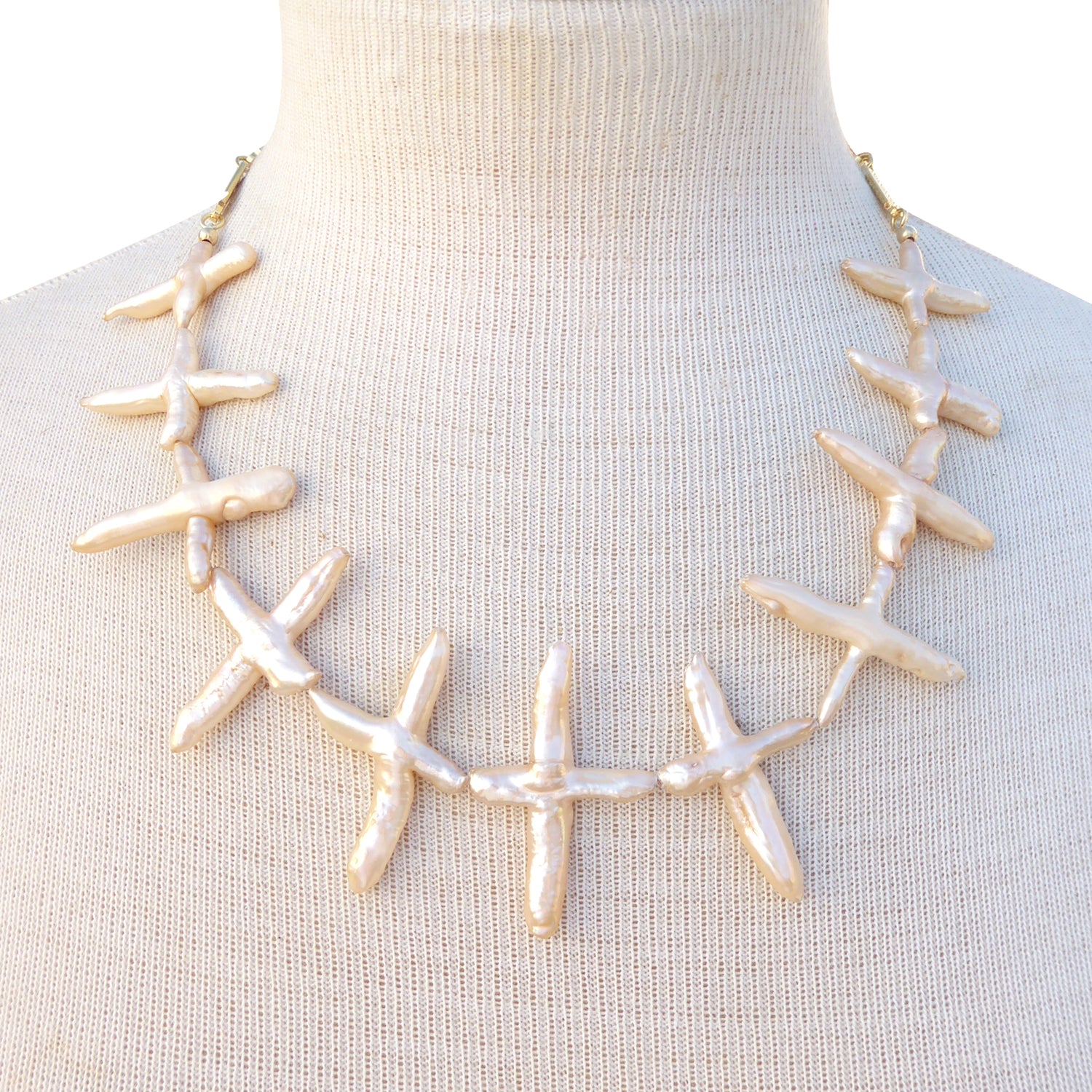 Pale peach pearl cross necklace