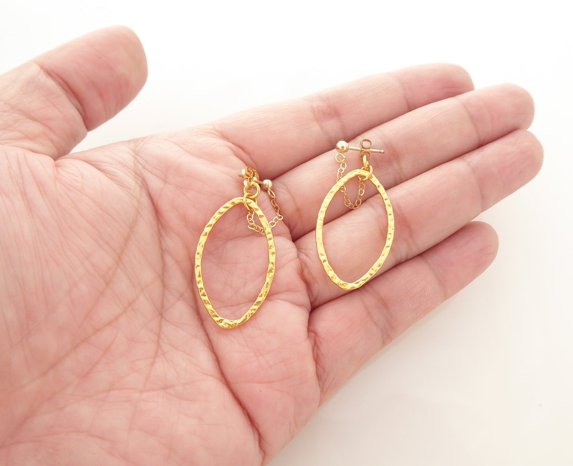 Gold saturn earrings in hammered